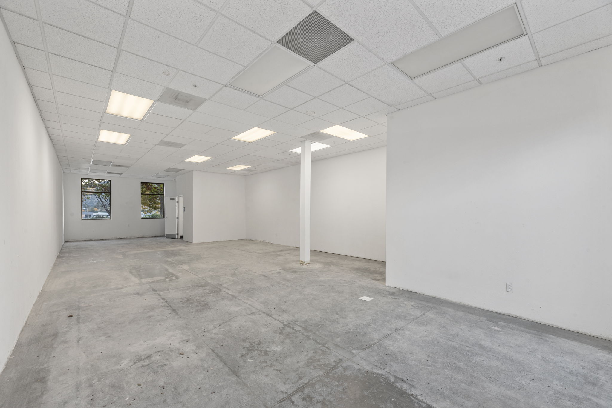1,200 SF retail shell — open layout, concrete floor, drop ceiling