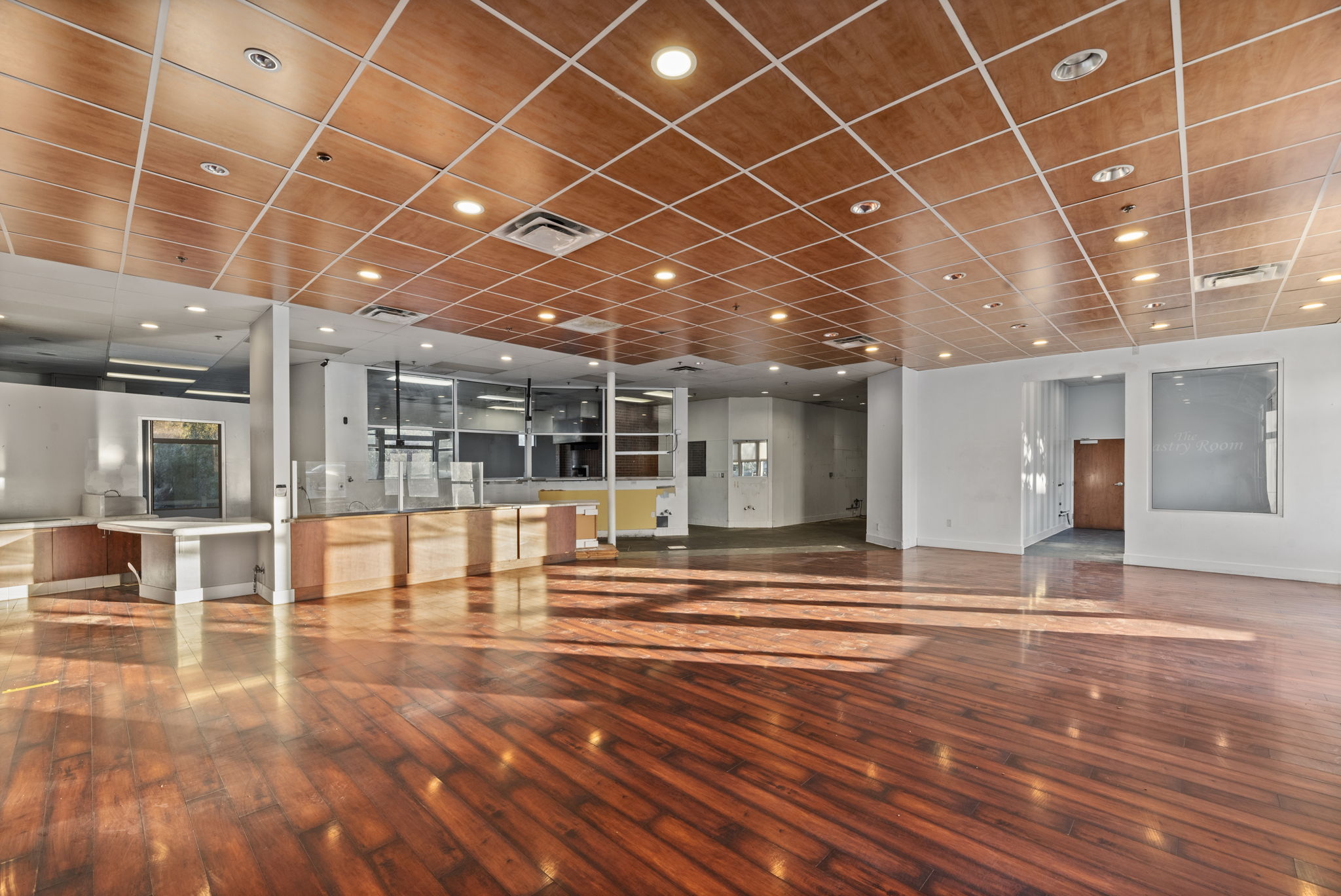 5,068 SF space — polished wood floor and warm wood-panel ceiling